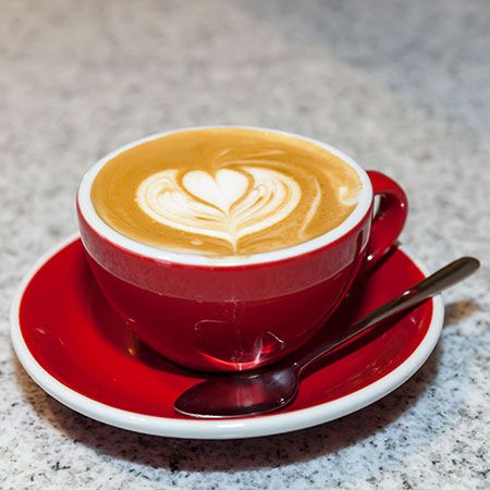 A cappuccino with a heart shape in the foam